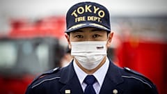 Japan's firefighters - like this member of the Tokyo fire department - are not permitted to hold second jobs