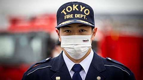 Japan's firefighters - like this member of the Tokyo fire department - are not permitted to hold second jobs