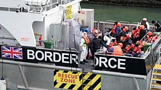 Migrants who made the crossing from France are brought into port after being picked up in the Channel by a British border force vessel in Dover, England, August 13, 2021.