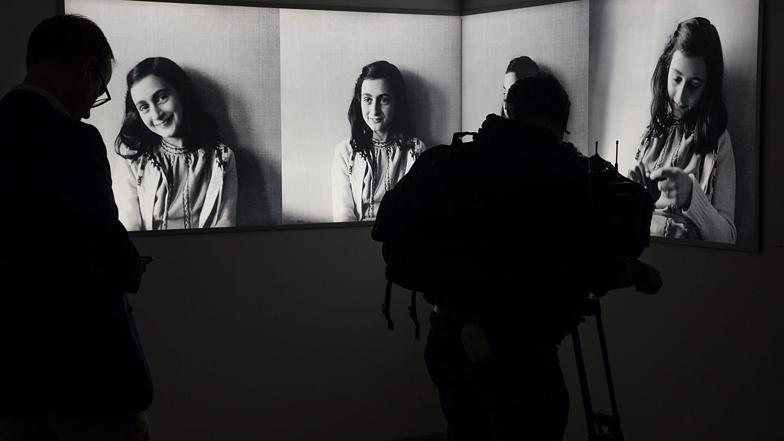 FILE- Journalist takes images of pictures of Anne Frank at the renovated Anne Frank House Museum in Amsterdam, Netherlands, Wednesday, Nov. 21, 2018. 