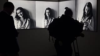 FILE- Journalist takes images of pictures of Anne Frank at the renovated Anne Frank House Museum in Amsterdam, Netherlands, Wednesday, Nov. 21, 2018.