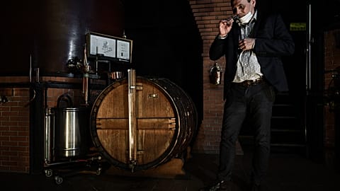 Distillery owner Eric Pinard checks the distillation process of Cognac, a white wine eau-de-vie obtained from a double distillation in a Charentais still 