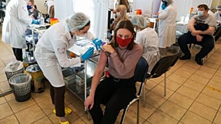 A medical worker administers a shot of Russia's Sputnik V coronavirus vaccine at a vaccination center in Moscow, Russia, Friday, Dec. 10, 2021.