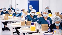 Technicians prepare Pfizer vaccines at Vaccination Centre in Sydney