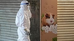 A staffer from the Agriculture, Fisheries and Conservation Department walks past a pet shop which was closed after some pet hamsters tested positive for COVID, in Hong Kong.