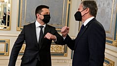 Ukrainian President Volodymyr Zelensky, left, touches elbows with United States Secretary of State Antony Blinken on the occasion of their meeting at the Bankova