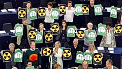 Green parties members of the European Parliament protest with anti-nuclear posters