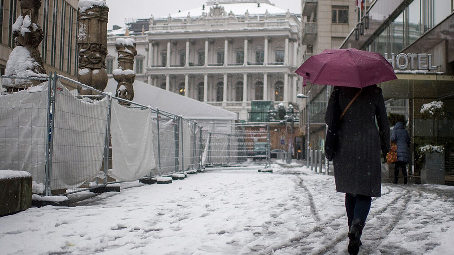 A person walks in front of the Palais Coburg in Vienna, Austria where talks on reviving the 2015 nuclear deal are proceeding behind closed doors