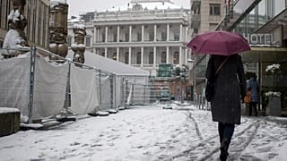 A person walks in front of the Palais Coburg in Vienna, Austria where talks on reviving the 2015 nuclear deal are proceeding behind closed doors