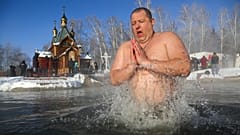A man bathes in water during a traditional Epiphany celebration as the temperature dropped to -24°C near the Achairsky monastery outside Siberian city of Omsk, Jan. 19, 2021.