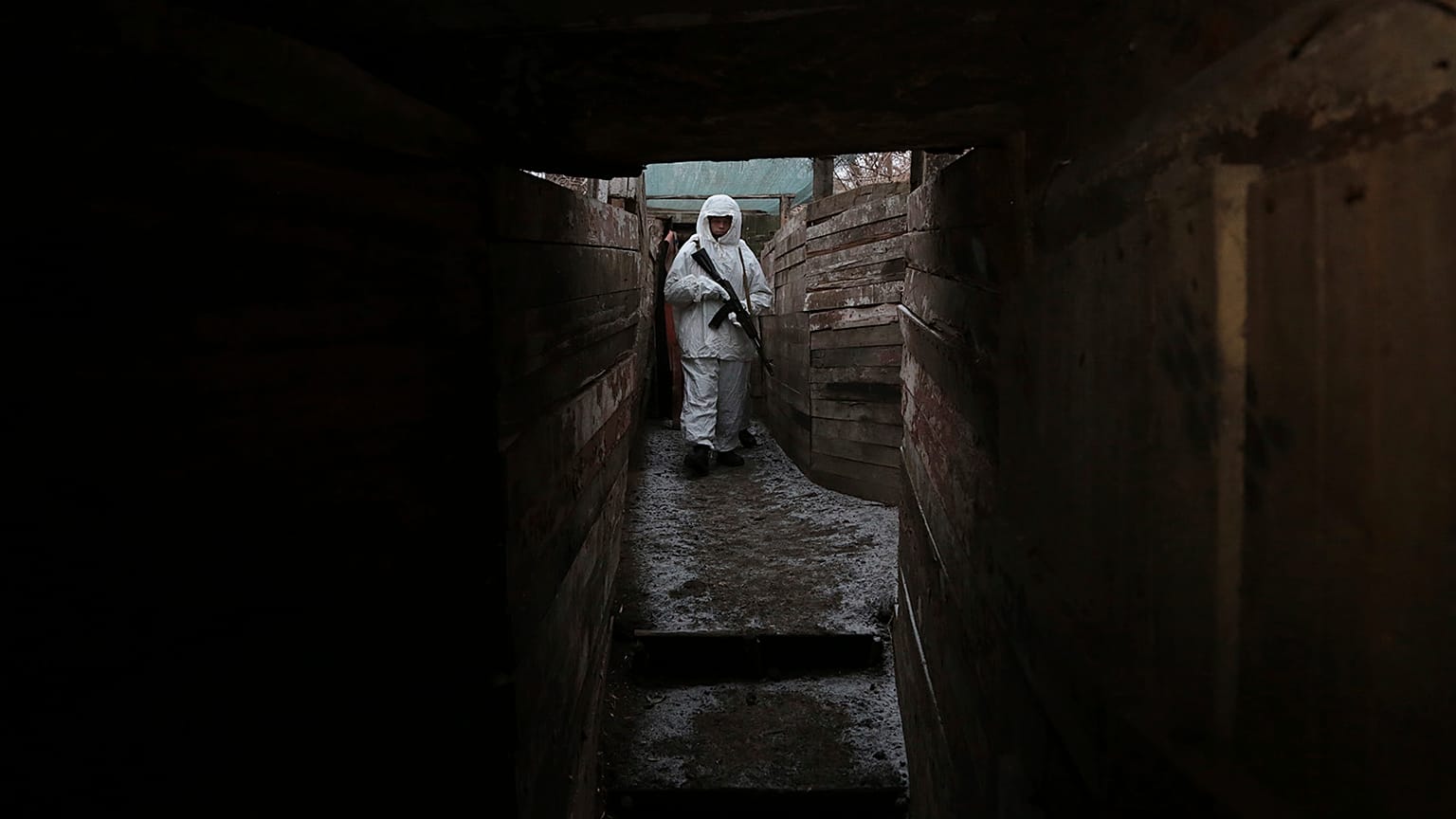 A serviceman takes his position in a trench at the line of separation near Yasne village, about 33,6 km south-west of Donetsk