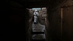 A serviceman takes his position in a trench at the line of separation near Yasne village, about 33,6 km south-west of Donetsk