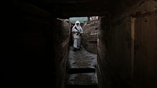 A serviceman takes his position in a trench at the line of separation near Yasne village, about 33,6 km south-west of Donetsk