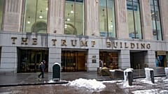 People walk by The Trump Building office building at 40 Wall Street in New York on Friday, Jan. 7, 2022.