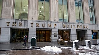 People walk by The Trump Building office building at 40 Wall Street in New York on Friday, Jan. 7, 2022.