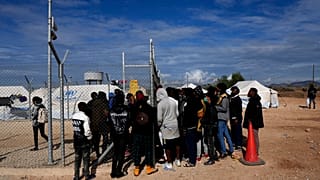 Migrants wait to be registered inside Pournara migrant reception center in Kokkinotrimithia outside the capital Nicosia, Cyprus