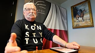 Poland's former president Lech Walesa wears a T-shirt reminding Poland's current right-wing government that it should respect the nation's constitution in his Gdansk office