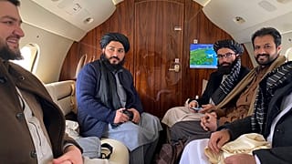 Taliban senior official member Anas Haqqani (R) and delegates sitting on a plane before departing to Oslo, at the Kabul airport in Kabul.