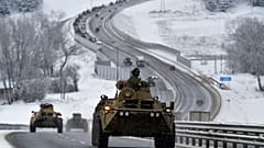 A convoy of Russian armoured vehicles moves along a highway in Crimea, Tuesday, Jan. 18, 2022.