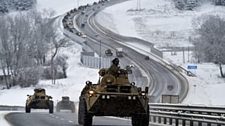 A convoy of Russian armoured vehicles moves along a highway in Crimea, Tuesday, Jan. 18, 2022.