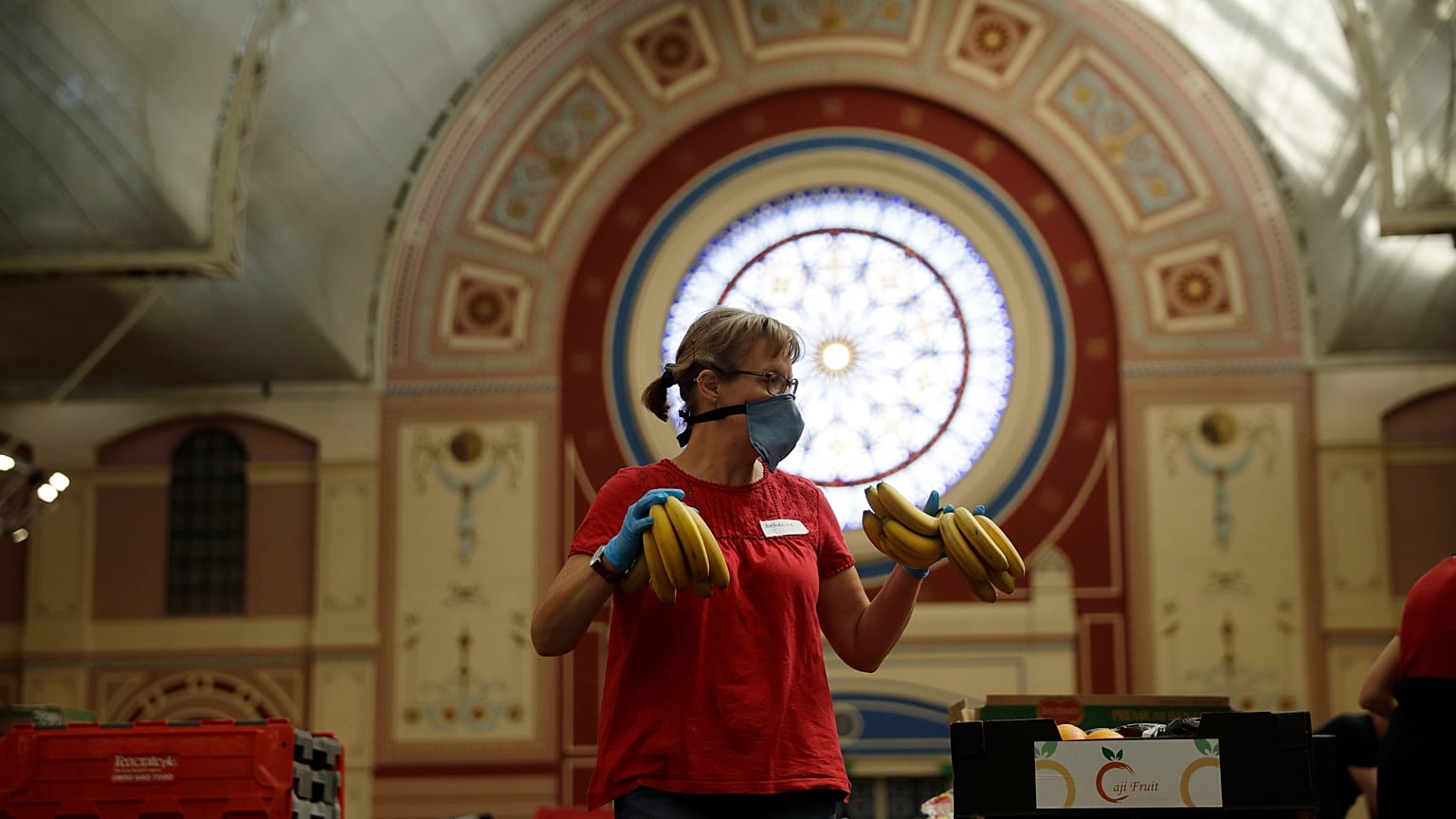 A volunteer for the Edible London food project checks bananas to be put in food packs and delivered to residents who need it in the Haringey Council area on April 21, 2020.