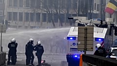 Police set off a water cannon against protestors during a demonstration against COVID-19 measures in Brussels, Sunday, Jan. 23, 2022