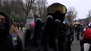 Man pushes camera and journalist is kicked leading to camera spinning around