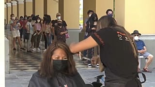 Una mujer dona su pelo para fabricar cilindros de contención