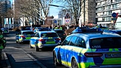 Police vehicles are parked on the grounds of Heidelberg University in Heidelberg, Germany, Monday, Jan. 24, 2022