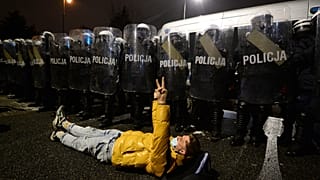 A protesters lies on the ground during a protest against new anti-abortion laws in Warsaw, Poland, Friday, Jan. 29, 2021
