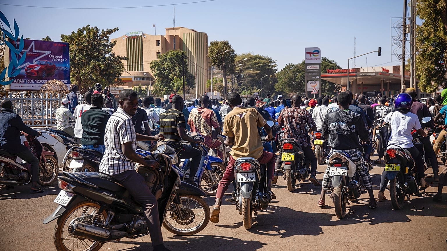 People cheer in support of putschist soldiers near the national television station in Ouagadougou, Monday, Jan. 24, 2022. 