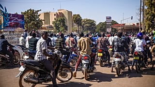 People cheer in support of putschist soldiers near the national television station in Ouagadougou, Monday, Jan. 24, 2022. 
