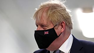 Britain's Prime Minister Boris Johnson wears a face mask, during a visit to Milton Keynes University Hospital in Buckinghamshire, England, Monday, Jan. 24, 2022. 