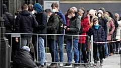 People with mandatory face masks line up to enter the Cathedral in Cologne, Germany, Friday, Jan. 7, 2022. 