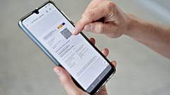 A woman checks her EU Digital Covid certificate on her mobile phone at El Prat airport in Barcelona.