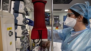 A nurse tends to a COVID patient in the intensive care unit at the Strasbourg University Hospital, eastern France, Thursday Jan. 13, 2022.