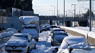 Stranded vehicles have been covered with snow for three days along the Attiki Odos road in Athens.