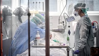 Medical personnel work in the intensive care unit of a hospital in Brescia, Italy early on in the pandemic, on 19 March 2020.