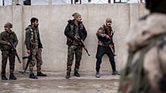 Syrian Democratic Forces soldiers hold a position in Hassakeh, northeast Syria, Thursday, Jan. 27, 2022