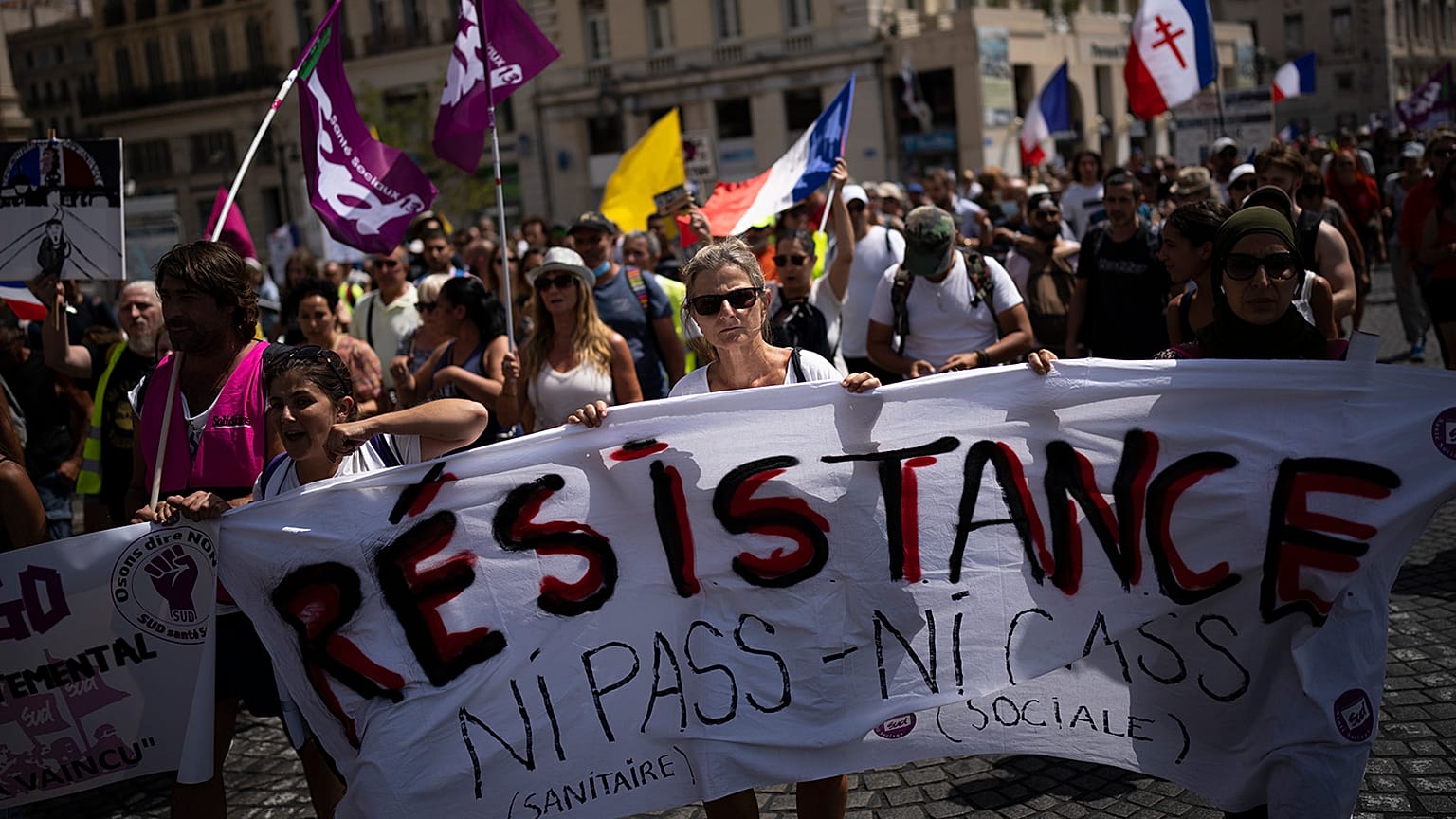 Protesters march during a demonstration to denounce a COVID-19 health pass needed to access restaurant, long-distance trains and other venues.