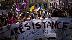 Protesters march during a demonstration to denounce a COVID-19 health pass needed to access restaurant, long-distance trains and other venues.