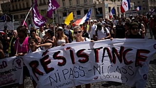 Protesters march during a demonstration to denounce a COVID-19 health pass needed to access restaurant, long-distance trains and other venues.