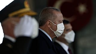 Turkey's President Recep Tayyip Erdogan stands with other Turkish leaders to lay a wreath on Republic Day, in Ankara