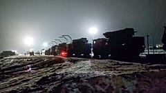 Russian military vehicles prepares to drive off a railway platforms after arrival in Belarus