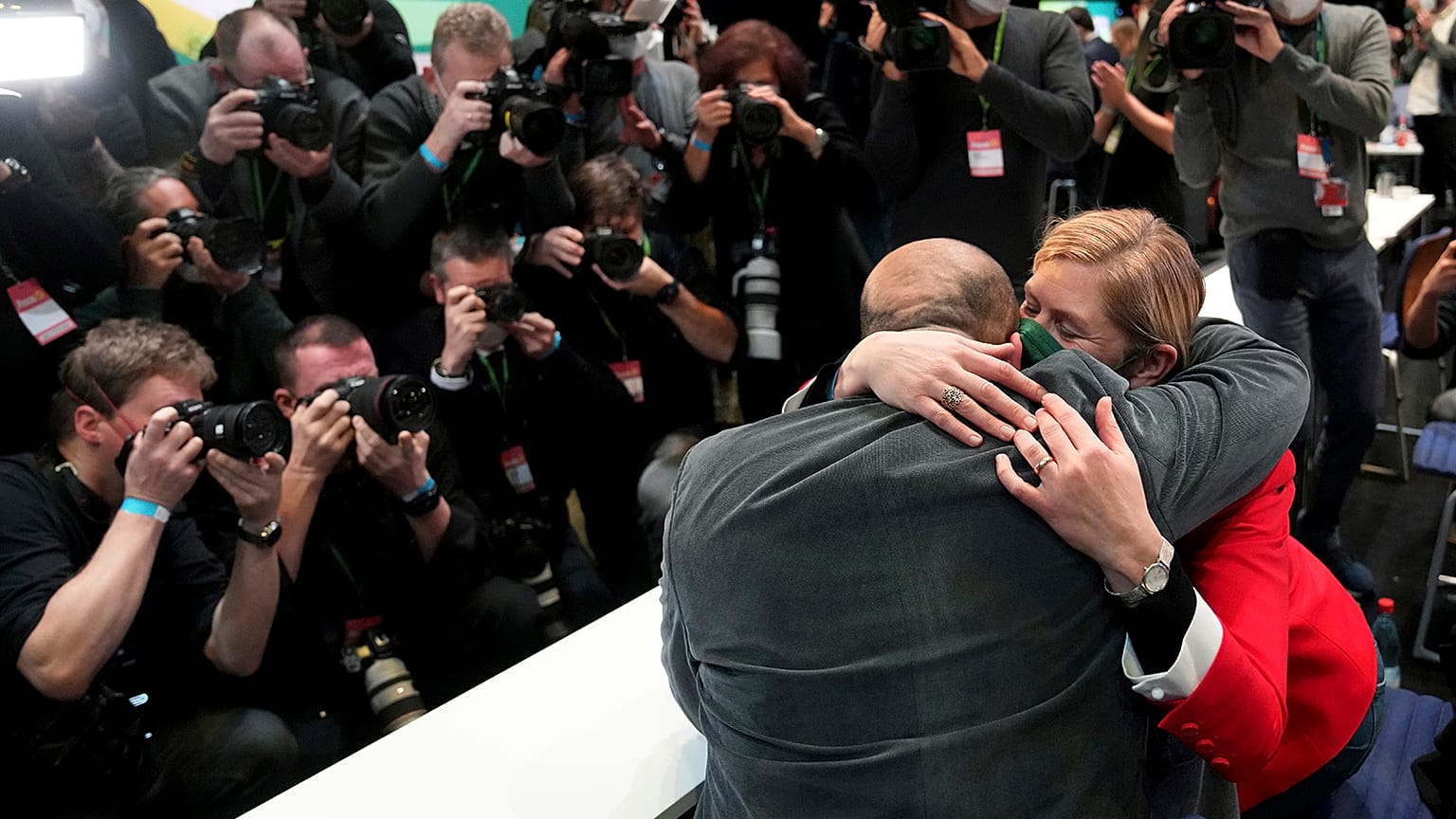 Omid Nouripour, newly elected party's co-chairman, is hugged by his wife Melanie Schnatsmeyer during a virtual party convention of the German Greens in Berlin