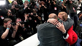 Omid Nouripour, newly elected party's co-chairman, is hugged by his wife Melanie Schnatsmeyer during a virtual party convention of the German Greens in Berlin