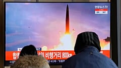 People watch a TV showing a file image of North Korea's missile launch during a news program at the Seoul Railway Station in Seoul, South Korea
