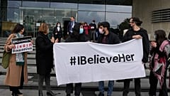 Protesters hold banners in support of the British woma, outside of Cyprus' Supreme Court in Nicosia.