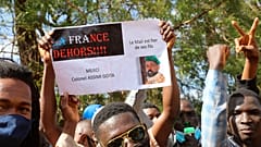 Thousands join a government-sponsored rally in Mali's capital Bamako Jan. 14, 2021 to protest new regional economic sanctions and growing pressure from France.