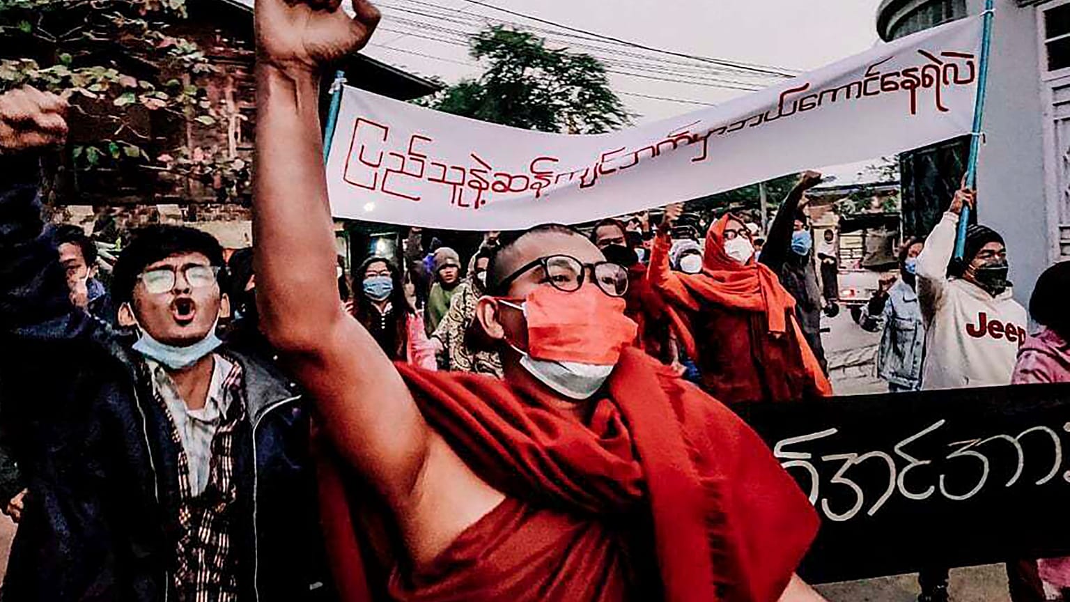 A Buddhist monk raises his clenched fist while marching during an anti-military government protest rally on Tuesday, Feb. 1, 2022, in Mandalay, Myanmar. 